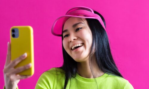 Asian girl laughing at her phone