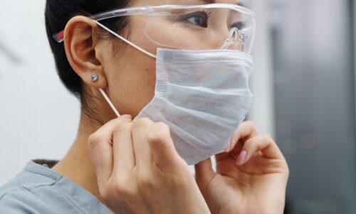 woman wearing protective mask and goggles